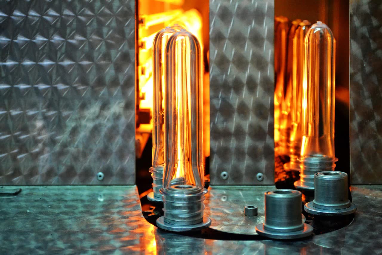 PET preforms glowing inside the heating oven of a blowing machine