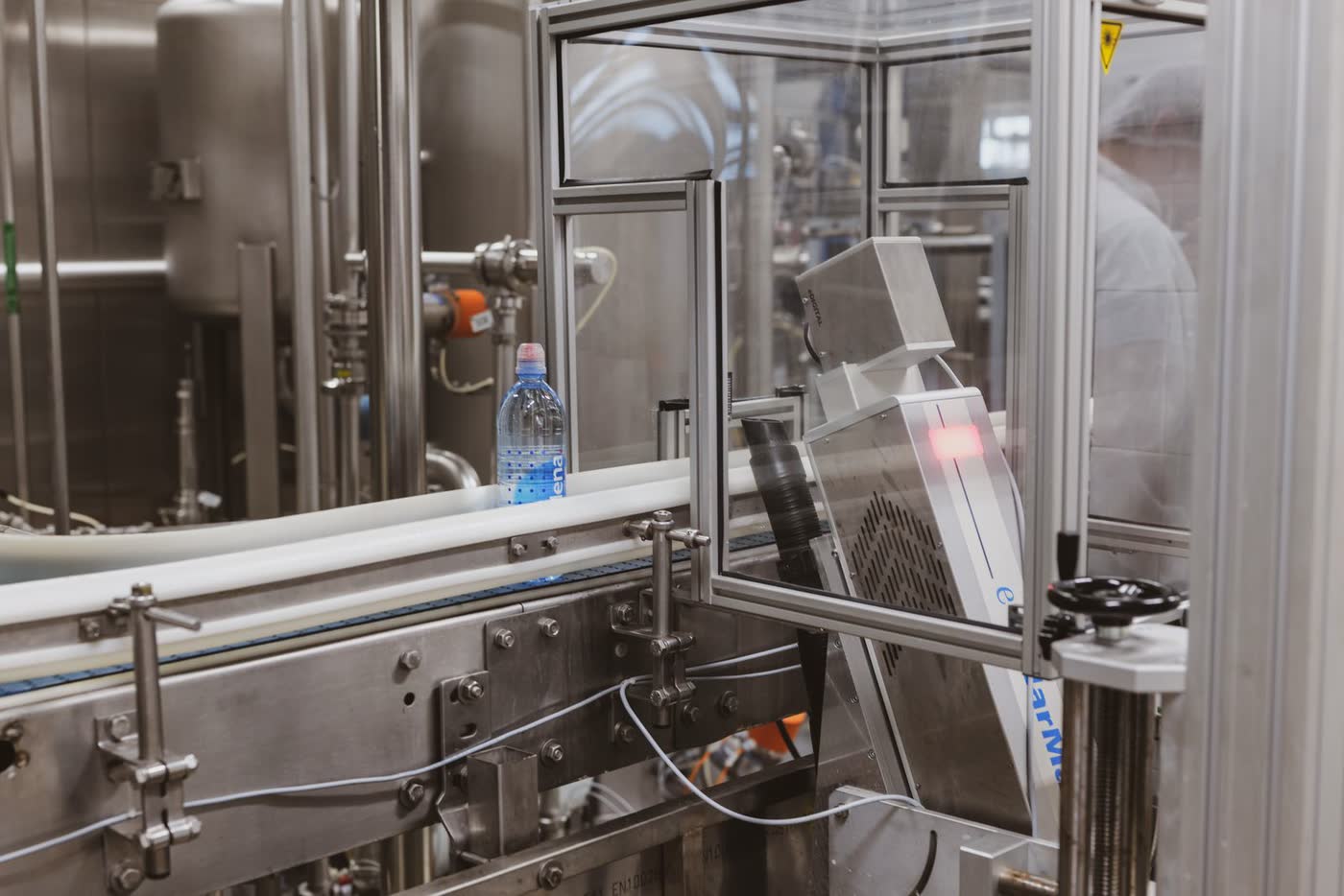 A bottle passing through an automated production machine